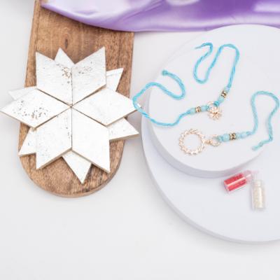 Shining Ties Diamond Rakhi Set with Kaju Katli