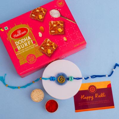 Divine Om Resin Rakhi & Dodha Burfi Delight - Rakhi Sweets to USA