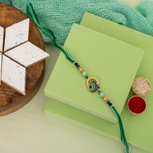 Peacock Feather Stone Rakhi with Premium Kaju Katli
