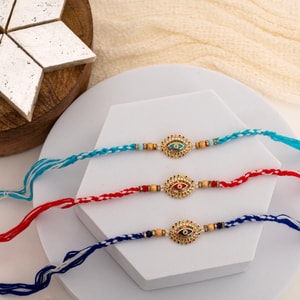 Evil Eye Rakhi Trio with Traditional Kaju Katli