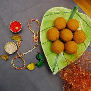 White Pearl Thread Rakhi with Besan Laddu
