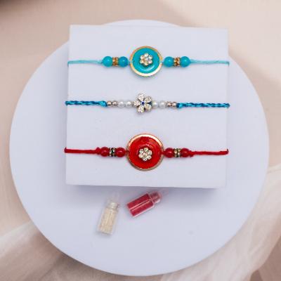 Contemporary Bonds: Artistic Thread Trio - Set of 3 Rakhis to USA