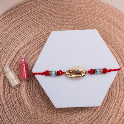 Glistening Golden Shell Rakhi