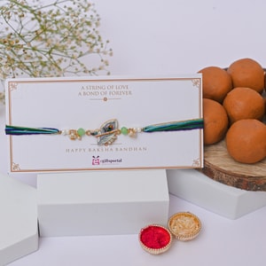 Krishna Flute Peacock Rakhi with Peda