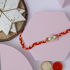Sacred Pearl Om Rakhi with Kaju Katli