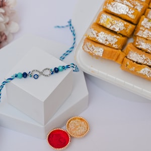 Infinity Evil Eye Rakhi with Patisa Sweet Box