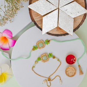 Designer Mint Green Bhaiya Bhabhi Rakhi Set with Kaju Katli